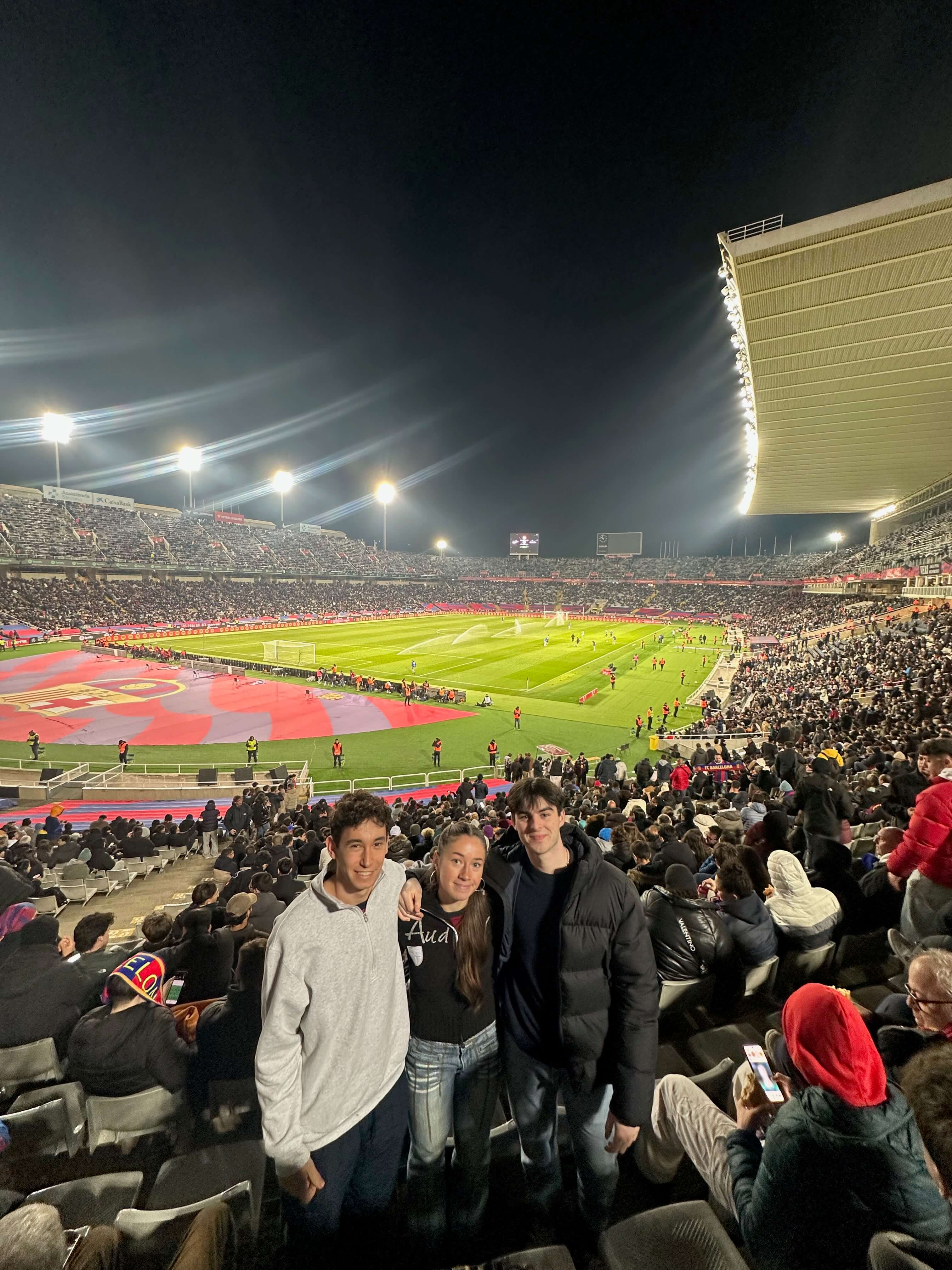 Friends posing inside Estadi Olímpic Lluís Companys during a Barcelona match