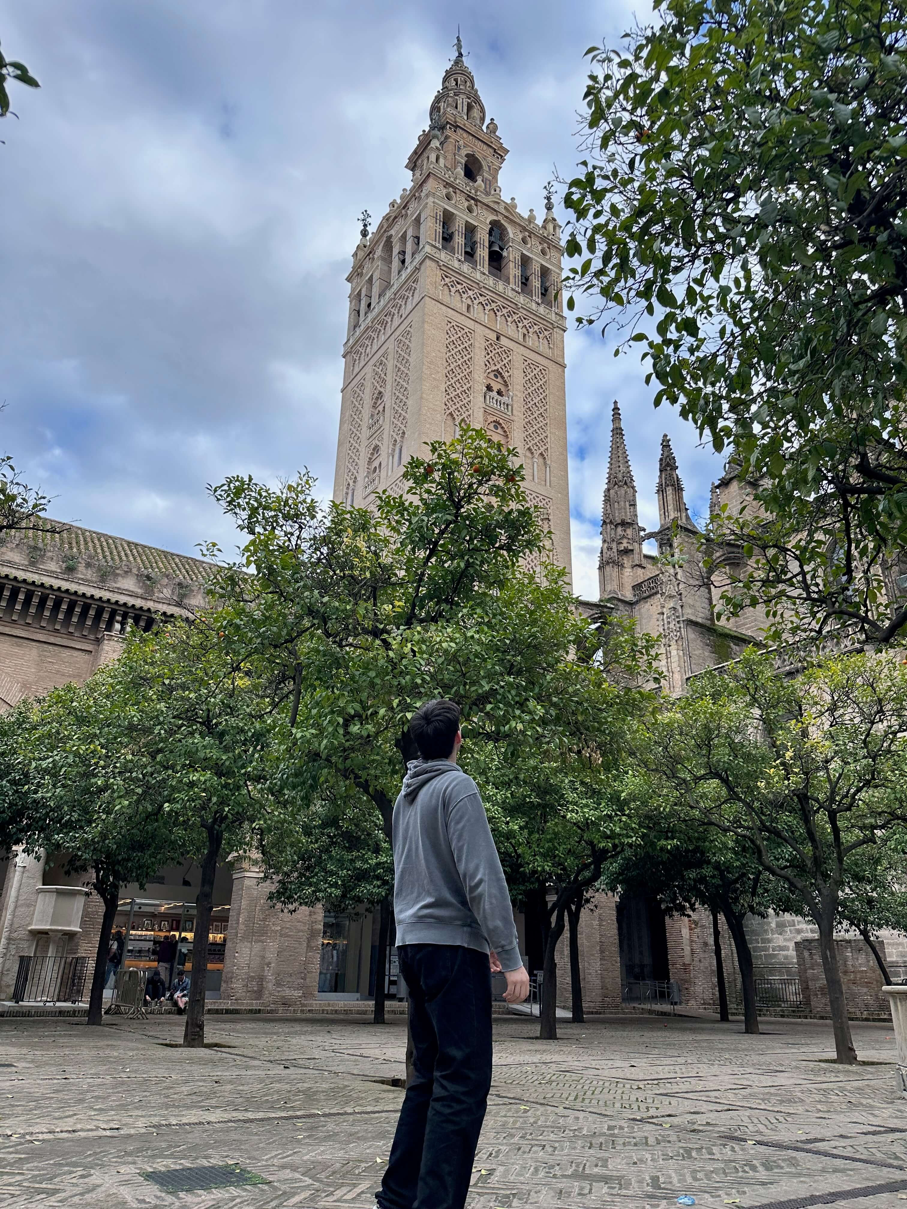 Lane looking up at La Giralda tower in Seville